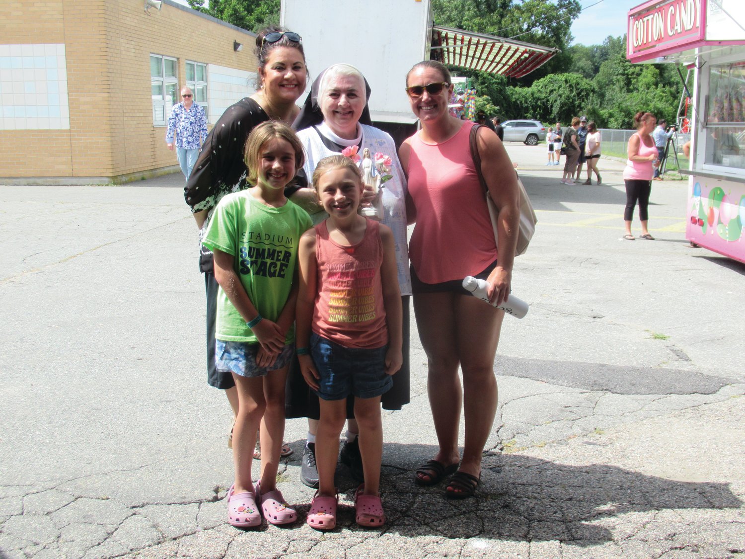 FAMILY FRIEND: Sister Donna welcomes the Berube family – Caroline, Abigail, and Stacie were among her many Saint Rocco’s friends that enjoyed the annual feast and festival.